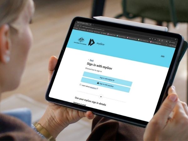 Woman using a tablet to access the myGov website, preparing to sign in and complete a TFN Declaration online.