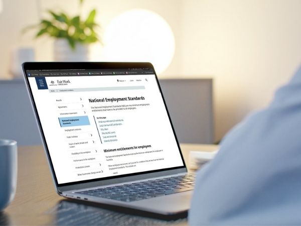 Person viewing the Fair Work website on a laptop, displaying the National Employment Standards for Australian employees.
